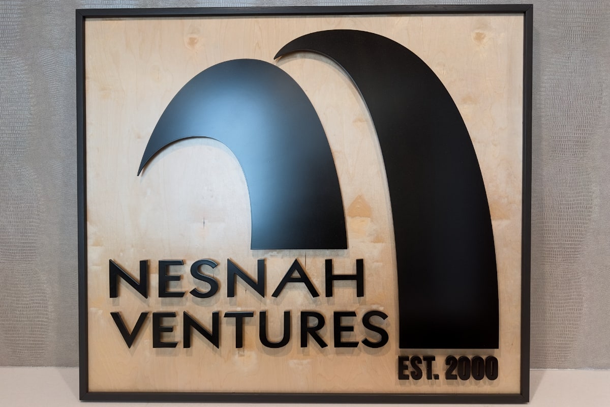 nv-front-lobby-logo nesnah ventures logo on wood background